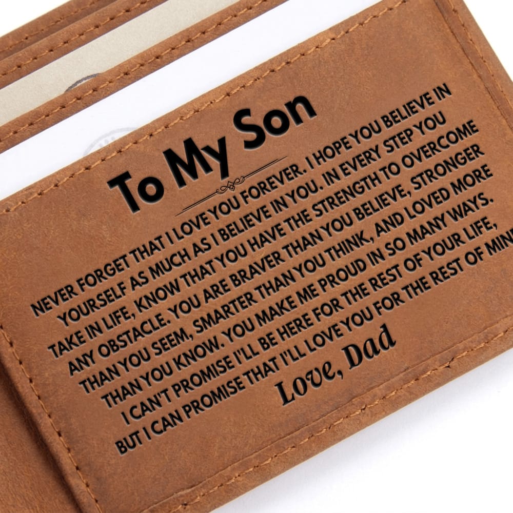 A close-up of a brown faux-leather wallet showing an engraved message for a son, with the text 'To My Son' and a heartfelt father's love message printed in black on the tan-brown surface.